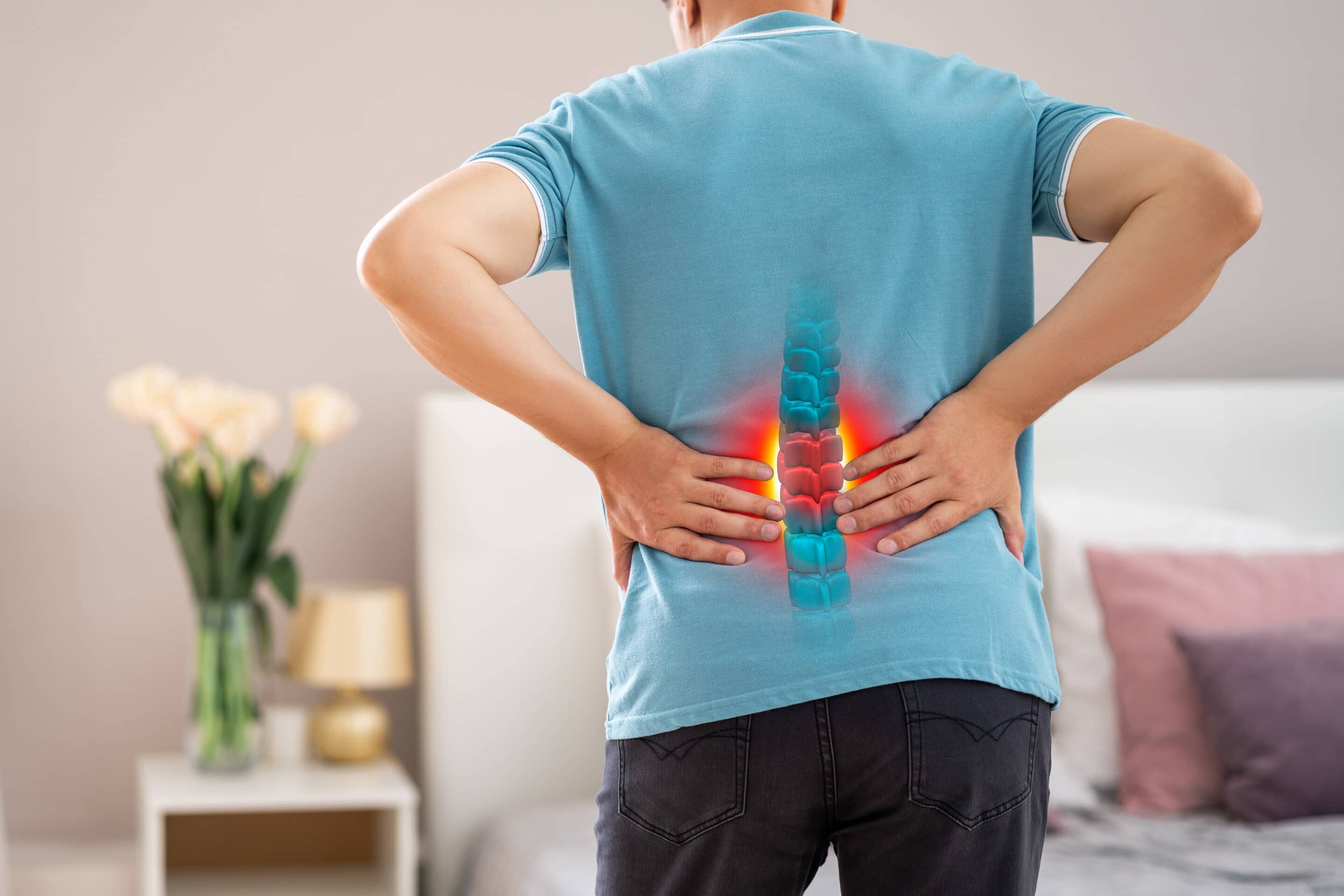 Lumbar spine hernia, man with back pain at home, compression injury of the intervertebral disc in the lower back, photo with highlighted skeleton